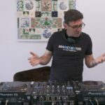 Andy Burnham at DJ Decks, headphones around his neck.